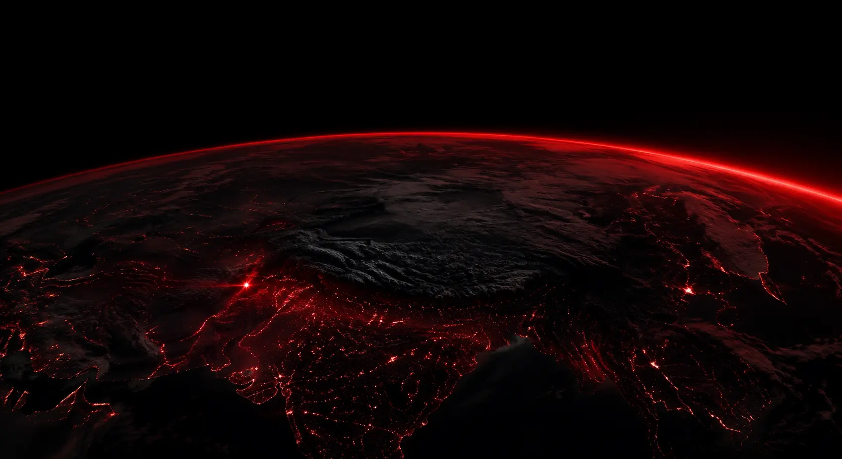 Earth at night with a crimson horizon and lights over South Asia
